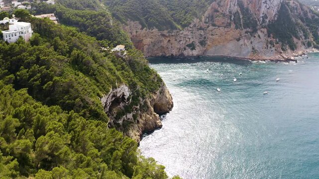 Aerial view of the anchorage and cliffs in Black Cape, in the Mediterranean village of Javea, Spain. 
