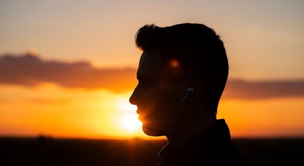 Fototapeta premium Man Silhouetted Against Sunset Sky.