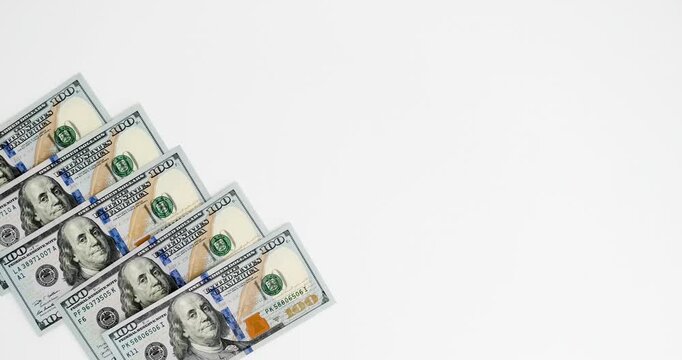 Dollar banknotes on a white background with a place for text. 4K stop motion animation
