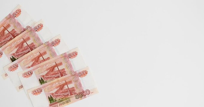 Five-thousand rubles banknotes on a white background with a place for text. Looped 4K stop motion animation