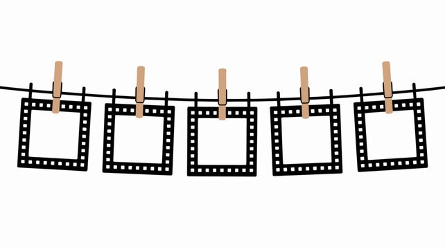Empty film frames hang on a black clothesline with wooden clothespins