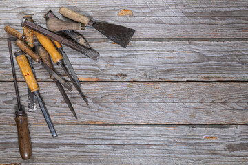 Assorted Vintage Hand Tools on Weathered Workbench with Right-Side Copy Space
