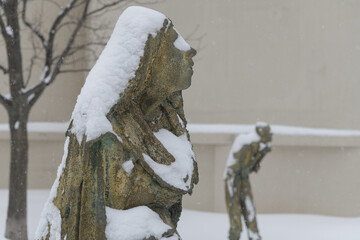 Naklejka premium Pregnant Woman created by Irish artist Rowan Gillespie part of The Arrival, set beside the old Canada Malting silos on Eireann Quay, Toronto, during winter storm on 2026-01-15