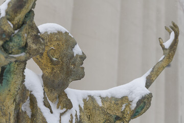 Obraz premium The Jubilant Man created by Irish artist Rowan Gillespie part of The Arrival, set beside the old Canada Malting silos on Eireann Quay, Toronto, during winter storm on 2026-01-15