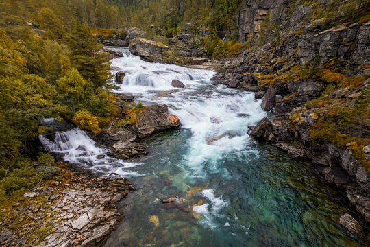 view of the picturesque Brufossen waterfall in the Rauma valley near Verma in central Norway