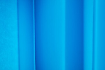 Obraz premium Abstract background of blue paper with folds and soft shadows.