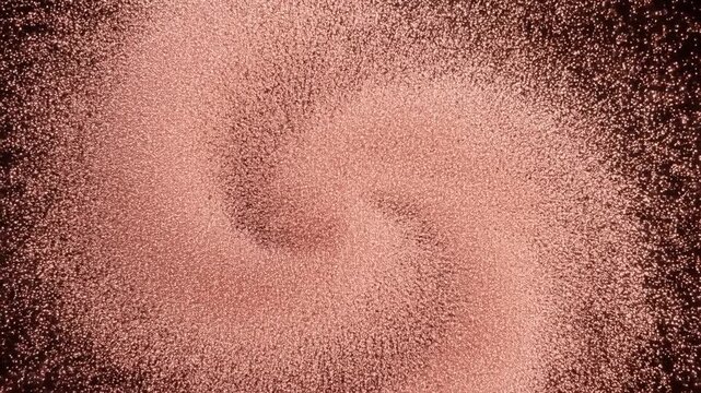 Macro shot of copper powder swirling in circular motion with metallic sheen