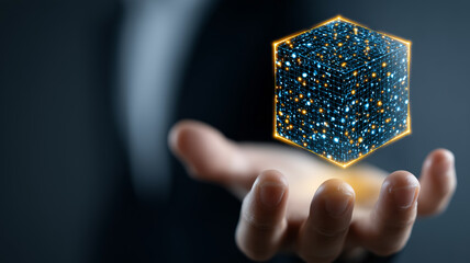 A glowing digital hexagon data shape floating above a human hand representing data storage systems and information architecture concepts.
