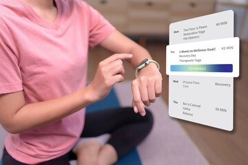 Woman checks her weekly yoga workout plan on a smartwatch fitness app to track progress toward her wellness goals smartwatch fitness app yoga schedule