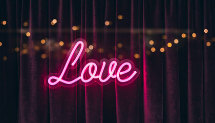 Pink "Love" neon sign on dark burgundy velvet curtains with golden bokeh lights, romantic theater or cabaret stage concept.