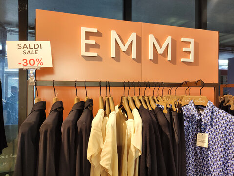 Rome, Italy - January 11, 2026: EMME clothing store display featuring stylish garments on hangers, showcasing a vibrant sale sign with discounts, creating an inviting shopping atmosphere