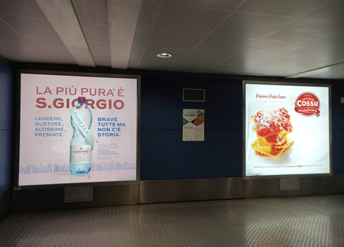 Cagliari, Italy - January 14, 2026: Advertising displays for S. Giorgio water and Cossu pastries in a modern urban setting, showcasing vibrant colors and enticing visuals for consumer engagement