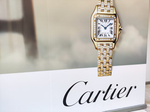 Cagliari, Italy - January 14, 2026: Cartier luxury watch displayed prominently on a stylish advertisement, showcasing its elegant design and craftsmanship in a sophisticated setting