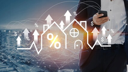 Businessman Holding Smartphone with Real Estate Growth Graph and House Icons in Background,...