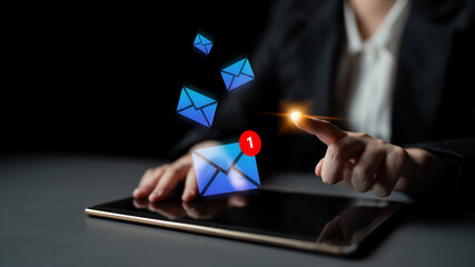 User interacts with email notifications on a tablet, showcasing the vital role of digital communication in contemporary professional environments and personal connectivity. Gantry