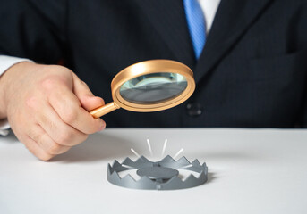 A businessman studies the trap. Rules for avoiding scams. Common mistakes newcomers make in...