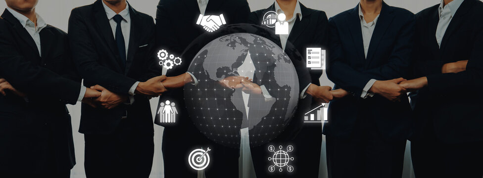 A diverse business team in formal attire represents collaboration and technology, emphasizing teamwork and innovation in a digital landscape for modern enterprises. Trope - Powered by Adobe