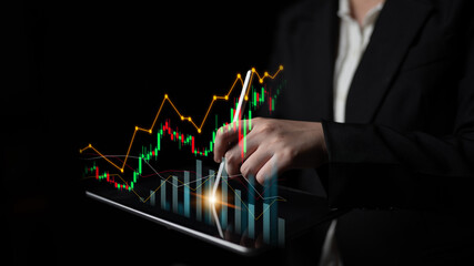 Professional businesswoman using a digital tablet to analyze stock market trends with vibrant graphs and charts, showcasing financial performance and investment strategies. Scalp