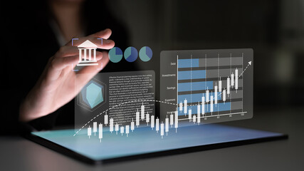A business person engages with digital financial information on a touchscreen device, showcasing...