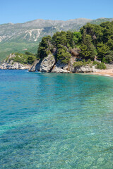 amazing Sveti Stefan beach in Budva riviera. Crystal clear waters on a sunny day