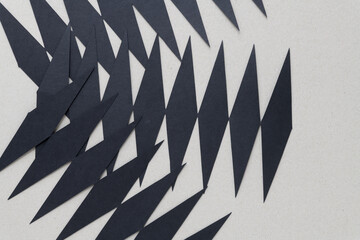 layered black paper diamond zigzag shapes on blank millboard