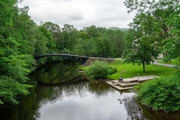 Fototapeta premium Historic Løkke Bro Cast-Iron Bridge in Sandvika Norway - Scenic River View in Løkkehaven Park
