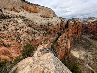 Fototapeta premium Grand sandstone canyon vista with deep ravines and towering rock formations, capturing the rugged beauty of a vast natural landscape beneath an expansive sky, inviting exploration