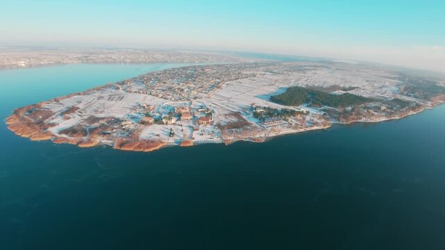FPV drone aerial shot. Beautiful nature landscape in winter of the Dniester River with a view of the island and clear blue sky. Moldova, Europe