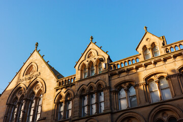 Fototapeta premium Newcastle upon Tyne UK: 17th Nov 2025: Newcastle Grainger Town showcases historic buildings against a clear blue sky in the late afternoon. The intricate design of the architecture captures attention