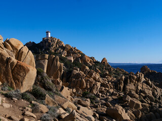 Wild rocky coastline of Capo di Muro in Corsica with crashing waves on Mediterranean Sea