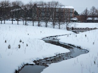 In the city at the creek, a fresh coating of winter snow in Eastbourne Park, Brapmton, Ont, Canada