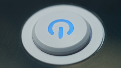 Detail of electric switch on/off control with illuminated symbol. Technology background with...