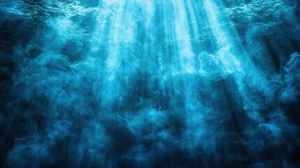 Sunlight beams piercing the deep blue ocean water creating a shimmering ethereal underwater scene with suspended particles