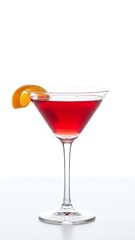 Isolated red cosmopolitan martini cocktail with lime and lemon garnish in a glass on a white background for a cold alcoholic bar refreshment