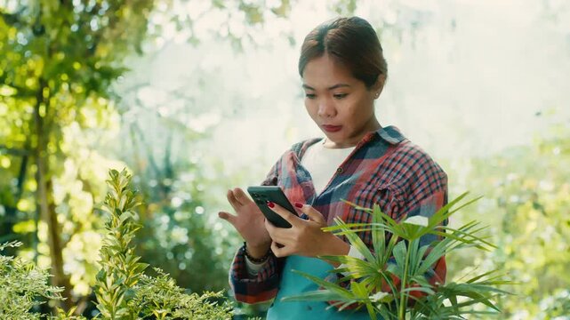 Woman Using Smart phone in Lush Garden