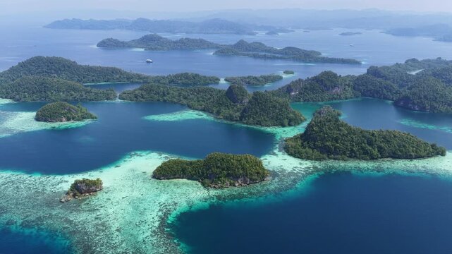Shallow coral reefs fringe the beautiful islands of Pef, Raja Ampat, Indonesia. This region harbors spectacular marine biological diversity and is a popular destination for divers and snorkelers.