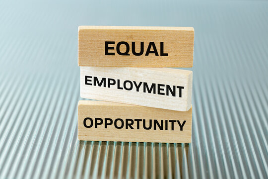 Symbol EEO, Equal Employment Opportunity. Business concept. Fair treatment in employment, no discrimination based on race, gender, religion, or nationality. Text on wooden blocks