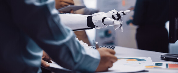 A modern office scene showcasing human and robot collaboration. Professionals engage with technology while presenting data and innovative ideas in a professional environment.Noogenesis