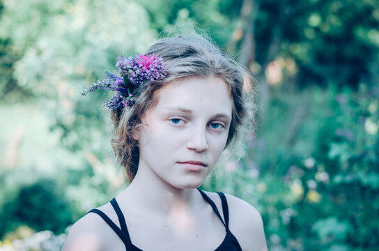 portrait of teenage girl with flowers in hair