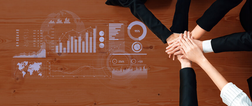 A diverse team collaborates over graphs and data analytics to drive professional growth and decision-making strategies in a modern office setting. Scalp - Powered by Adobe