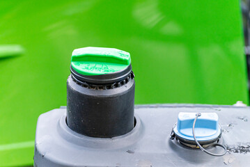 Green Diesel Fuel Cap and Blue AdBlue Cap on a Tractor The Concept of Modern Agriculture
