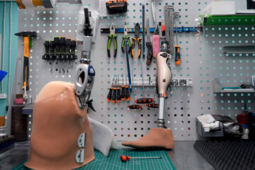 Prosthetic limb in a workshop, using tools and materials to create a custom replacement for a person with a disability