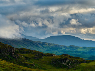 Rocky terrain blends with lush greenery in a serene, untouched landscape.