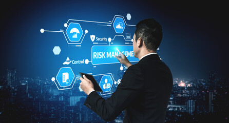 A business professional engages with an advanced digital display focused on risk management in a modern urban environment, emphasizing technology and strategy. Tessel