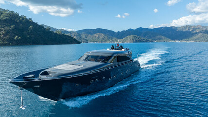 Elegant Yacht Cruising the Calm Ocean: A sleek, modern yacht gracefully cuts through the serene, turquoise water, propelled by the boundless energy of the open sea. It's a symphony of power and peace.