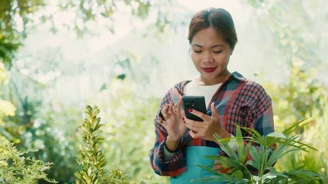 Woman Using Smart phone in Lush Garden