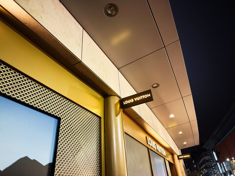 Louis Vuitton store exterior at night in Manchester UK with modern architecture and illuminated signage
