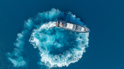 Dynamic Boat in the Deep Blue: A boat carves a mesmerizing path on the surface, leaving a trail of churning water in its wake. The sea and the vessel is a symphony of motion. 