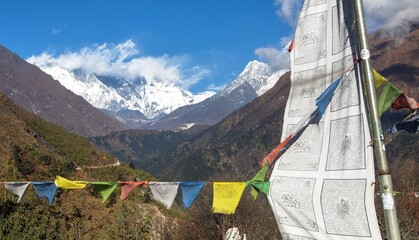 Mount Lhotse south rock face with buddhist prayer flags