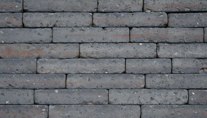 Fototapeta premium Close-up view of a weathered brick wall with gray and brown bricks